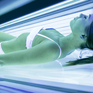 Lady Inside A Tanning Bed