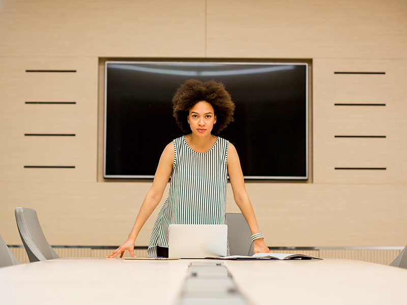 Lady stands In Front Of An Office TV