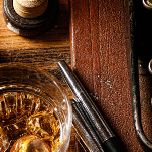 Old Typewriter On A Desk Next To A Whiskey