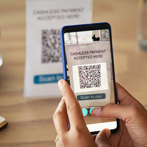 Holding A Cell Phone With A QR Code On It