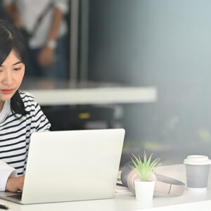 Lady At Her Desk On Her Laptop Computer