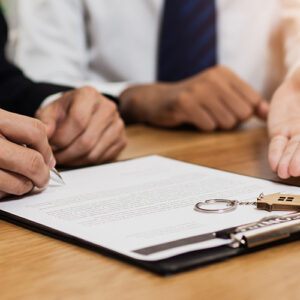 Two People Signing A Real Estate Contract