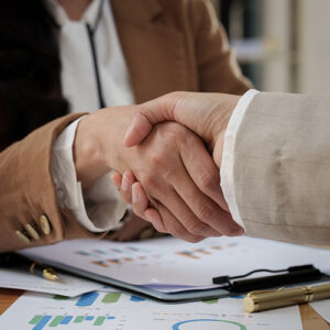 Two People Shake Hands Over A Small Business Funding Idea
